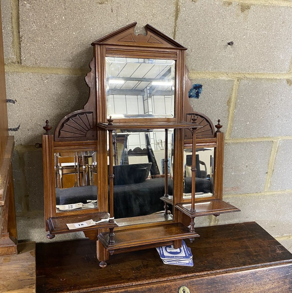 A late Victorian mahogany mirrored wall bracket, width 58cm, height 74cm